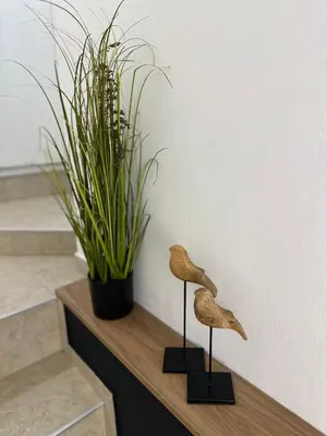 two bird sculptures sitting on a counter next to a plant at Studio with TERRACE - city center in Plovdiv