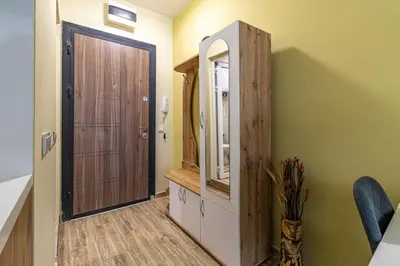 a bathroom with a wooden cabinet and a mirror at Ishirkov Residence Studio in Sofia