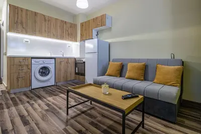 a living room with a couch and a table at Ishirkov Residence One Bedroom Apartment in Sofia