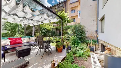 an outdoor patio with a couch and a table at Cozy 1BR Flat next to NDK with Private Patio in Sofia