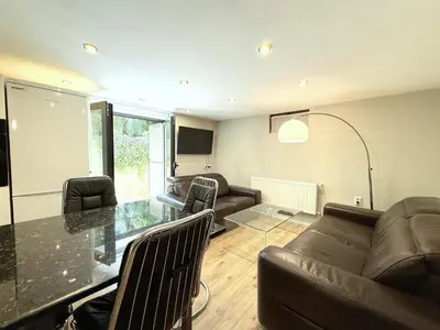 a living room with a couch and a table at Cozy 1BR Flat next to NDK with Private Patio in Sofia