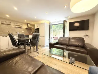 a living room with a couch and a table at Cozy 1BR Flat next to NDK with Private Patio in Sofia
