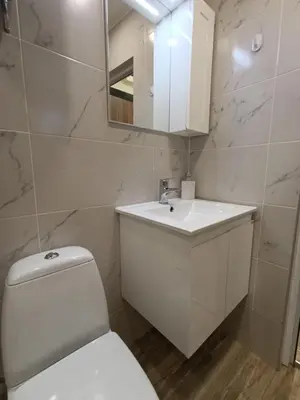 a bathroom with a white toilet and a sink at Ishirkov Residence Studio 2 in Sofia