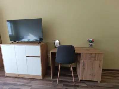 a room with a desk with a tv and a chair at Ishirkov Residence Studio 2 in Sofia