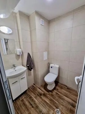 a bathroom with a toilet and a sink at Comfort family apartments in Sofia