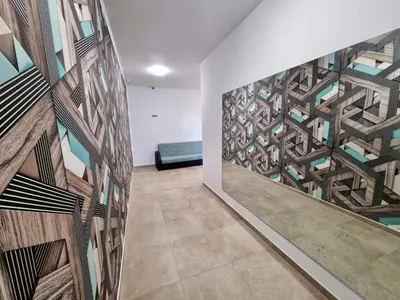 a room with a wall with a mural of a building at Comfort family apartments in Sofia
