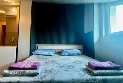 a bedroom with a bed with two pillows on it at Super economy studios in Sofia