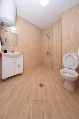a bathroom with a toilet and a sink and a shower at Easy studios in Sofia