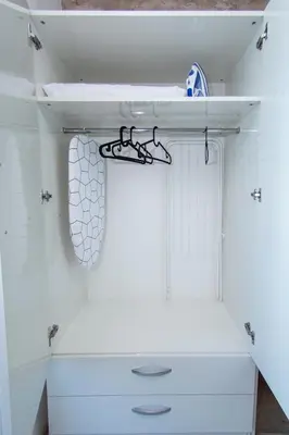 a closet with white cabinets and a towel rack at Easy studios in Sofia