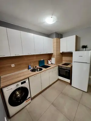 a kitchen with a washing machine and a sink at Gabana apartments in Sofia