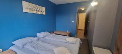 a blue bedroom with a bed in a room at Yubim rooms in Sofia