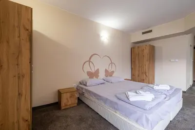 a bedroom with a bed with a heart on the wall at Yubim rooms in Sofia
