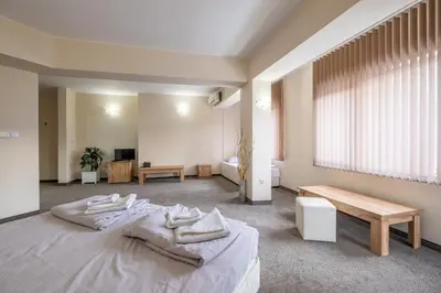 a bedroom with a bed with towels on it at Yubim rooms in Sofia