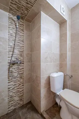 a bathroom with a toilet and a shower at Yubim rooms in Sofia