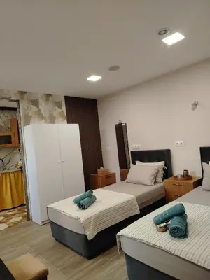 a bedroom with two beds with towels on them at Good Mood Apartments & Parking 2 in Plovdiv