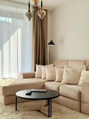 a living room with a couch and a table at Selena Apartment 50m to Metro with Free Parking in Sofia