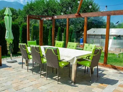 a table and chairs with a table and an umbrella at Villa Stemara in Razlog