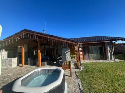 a bath tub in front of a house at Villa Stemara in Razlog