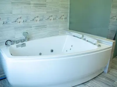 a white bath tub in a bathroom with a mirror at Villa Stemara in Razlog
