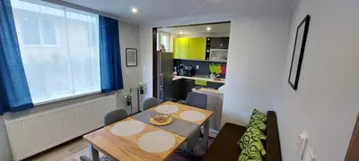 a dining room with a table and a kitchen at Stoykite view in Stoykite