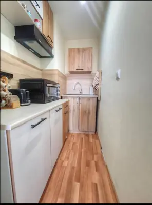a small kitchen with a sink and a microwave at Nevena 206 B&P in Bansko