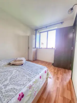 a bedroom with a bed and a large window at Nevena 206 B&P in Bansko