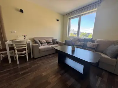 a living room with a couch and a table at 63rd Luxury One Bedroom Apartment in Sofia
