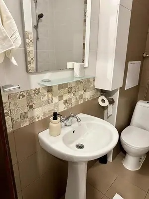 a bathroom with a white sink and a toilet at Apartment top center Maria in Sofia