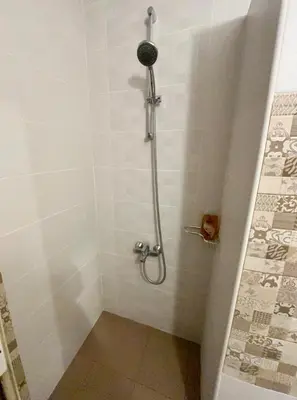 a shower stall in a bathroom with a shower at Apartment top center Maria in Sofia
