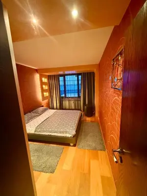 a small bedroom with a bed and a window at Apart Burel 56 in Sofia