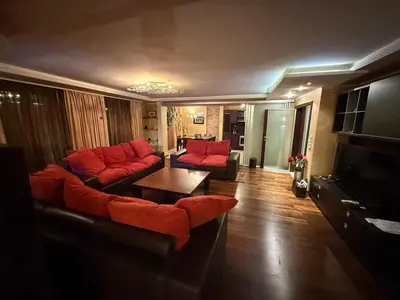a living room with a couch and a table at Apart Burel 56 in Sofia