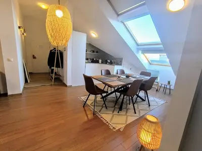 a dining room and kitchen with a table and chairs at Bansko LUXURY 2 bedroom apartment - SKI&SPA resort in Bansko