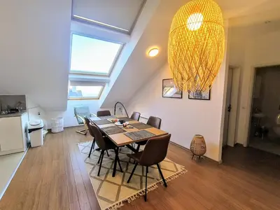 a dining room with a table and chairs and a chandelier at Bansko LUXURY 2 bedroom apartment - SKI&SPA resort in Bansko