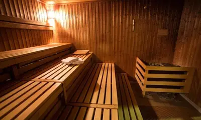 a wooden sauna with two benches in a room at Bansko LUXURY 2 bedroom apartment - SKI&SPA resort in Bansko