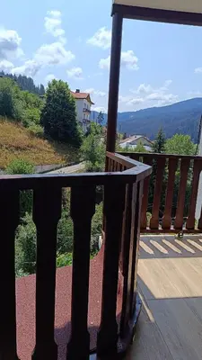 a view of a balcony with a table on a porch at Родопско сърце in Chepelare
