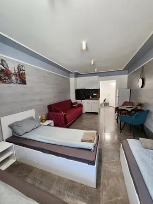 a bedroom with a bed and a red couch at Continental studios 4 in Sofia
