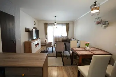 a living room with a table and a dining room at Monte Verde in Velingrad