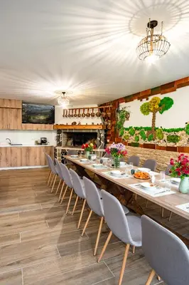 a large dining room with a long table and chairs at Къща за гости Крис in Smolyan