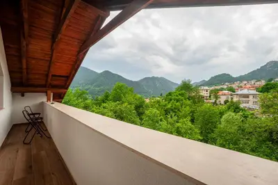 a balcony with a view of trees and mountains at Къща за гости Крис in Smolyan