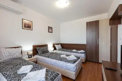 a living room with two beds and a couch at Belvedere 2bedroom private apartment in Bansko
