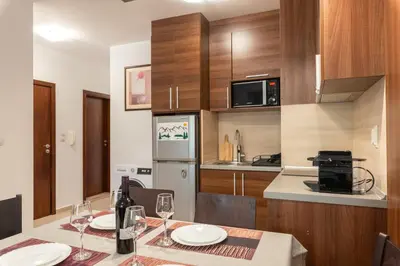 a kitchen with a table with wine glasses at Belvedere 2bedroom private apartment in Bansko