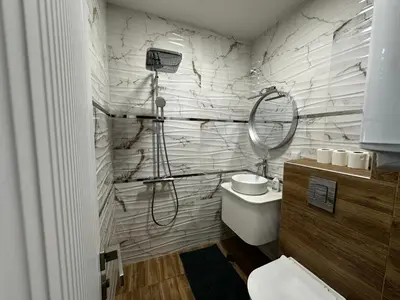 a white bathroom with a shower and a toilet at Delux 3 - Plovdiv Модерен апартамент,2 спални,център in Plovdiv