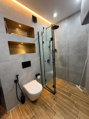 a bathroom with a toilet and a glass shower at Atana Home Drujba in Sofia
