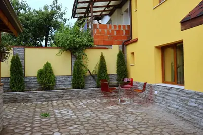 a group of chairs sitting outside of a building at Guest house Dinaya-2 in Dobrinishte