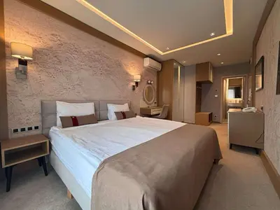 a bedroom with a large bed in a room at MG Homes - City Park Inn in Plovdiv