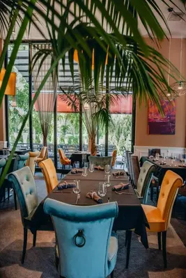 a dining room with a table and chairs and a table and chairsktop at MG Homes - City Park Inn in Plovdiv