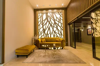 a living room with a yellow couch and a table at MG Homes - City Park Inn in Plovdiv