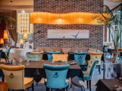 a restaurant with tables and chairs and a brick wall at MG Homes - City Park Inn in Plovdiv