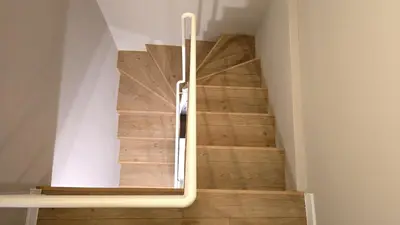 a spiral staircase with a white rail in a room at Hidden Courtyard Gem - House in Sofia Center in Sofia
