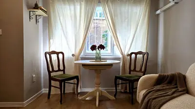 a table in a room with two chairs and a window at Hidden Courtyard Gem - House in Sofia Center in Sofia